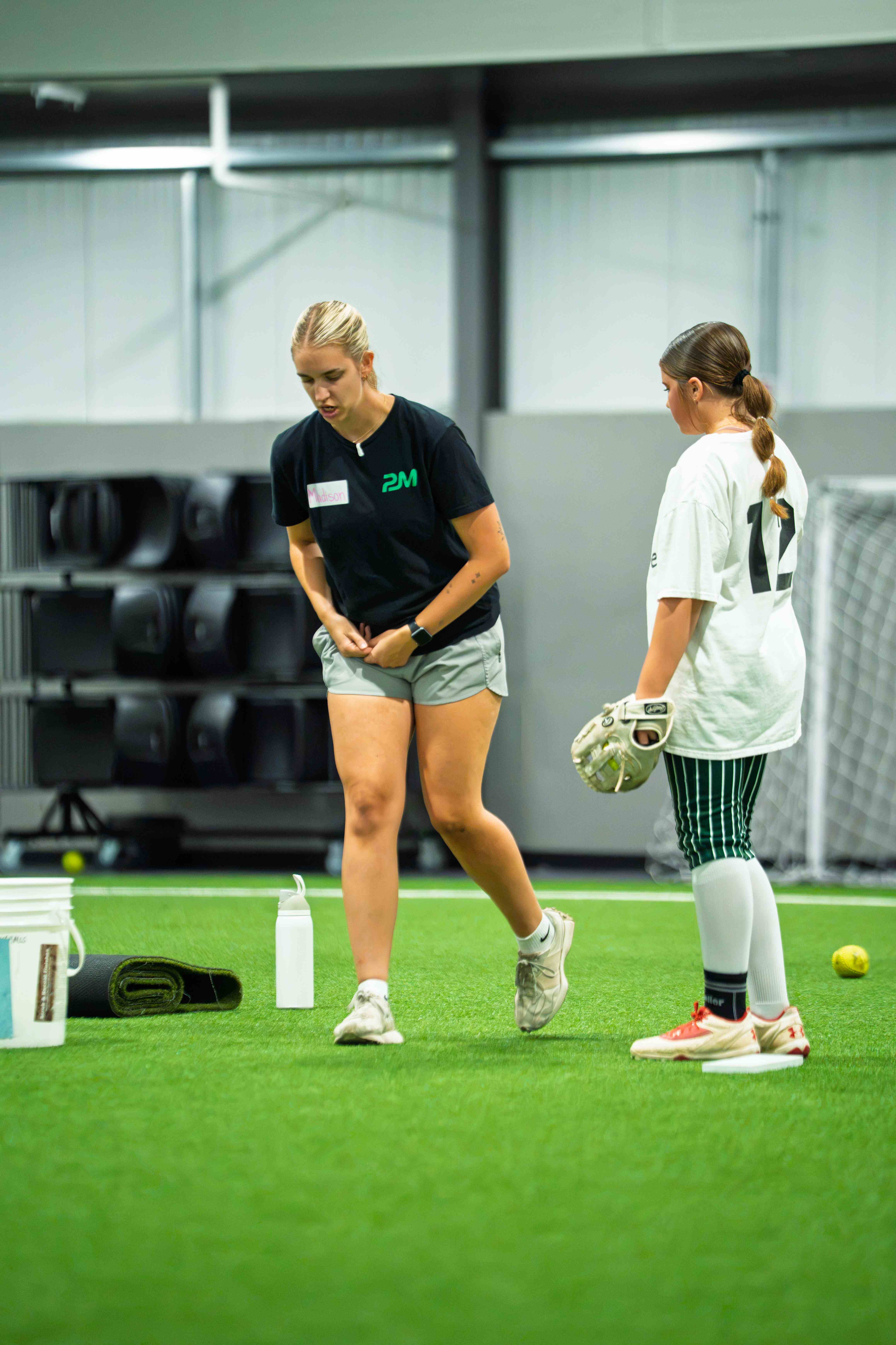 Coach giving a one-on-one lesson to a young player