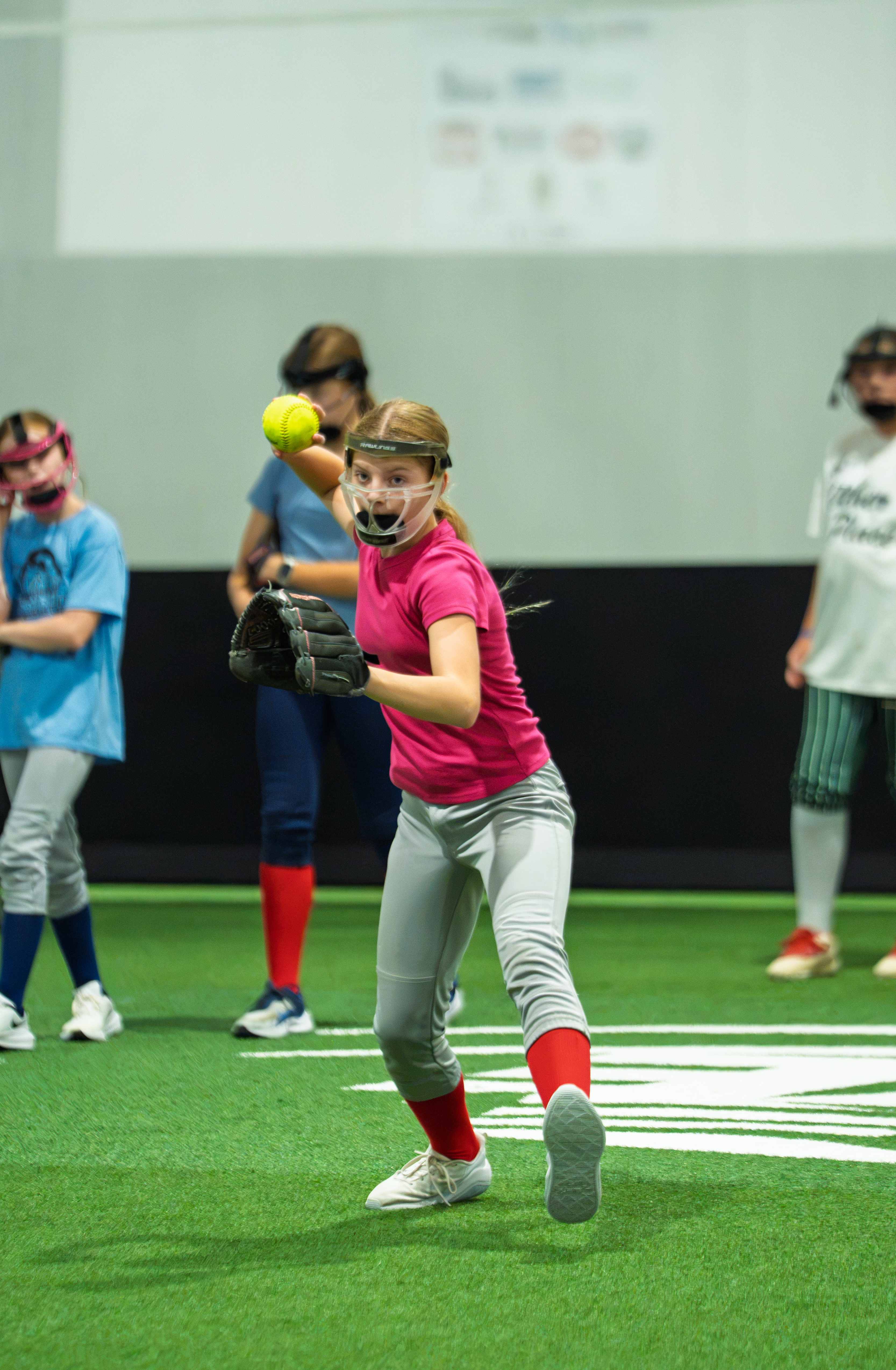 Player throwing during a group lesson with teammates
