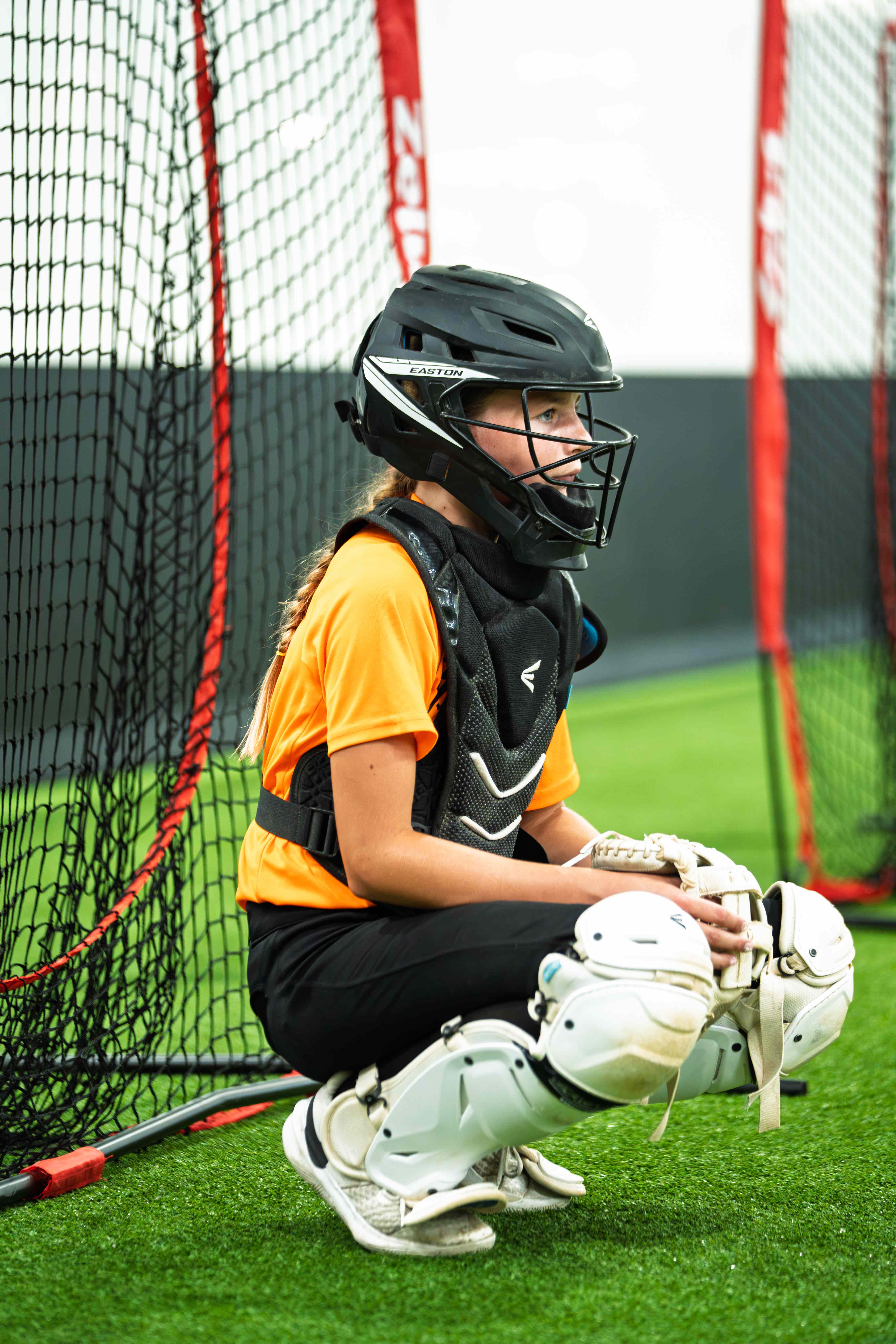 Young catcher in full gear during an individual lesson